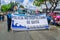 Quito, Ecuador - January 31, 2018: Outdoor view of unidentifed women holding an informative sign with a truck full of