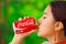 Quito, Ecuador - May 06, 2017: Close up of a beautiful young indigenous woman drinking a coke in a forest background