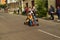 Quito, Ecuador - May 06, 2017: An unidentified couple racing on a wooden car in urban road inside of the streets of city