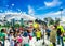 QUITO, ECUADOR- NOVEMBER, 28, 2017: Outdoor view of woman with foam machine and group of children enjoying and dancing