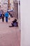 QUITO, ECUADOR NOVEMBER, 28, 2017: Unidentified people walking in the streets close to a poor woman selling garlic