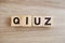 Quiz letters alphabet wooden cubes on wooden background