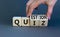 Quiz or question symbol. Businessman hand turns cubes and changes the word `quiz` to `question`. Beautiful grey background.