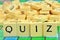 Quiz written with letters from a scrabble game close up