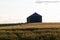 Quonset huts in a beautiful wheat field, at sunset, in central Alberta, Canada. Scenic view