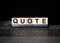 Quotes - word from wooden blocks with letters, citation official notice or quotation concept, grey background
