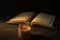 The Qur`an, the holy book of Islam. worship month of Ramadan, reading the scriptures by using a candle light.