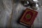 Quran and candles on a wooden surface.