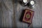 Quran and candles on a wooden surface.