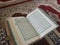 Quran on elegant Persian rugs - the Arabic text with English translation.