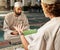 Quran, muslim and mosque with an imam teaching a student about religion, tradition or culture during eid. Islam, book or