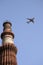 Qutb Minar tower and a plane, Delhi, India