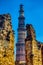 Qutb Minar tower seen through the ruined Quwwat ul-Islam Mosque at Qutub Minar complex - New Delhi, India