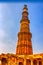 Qutb Minar tower seen through the ruined Quwwat ul-Islam Mosque at Qutub Minar complex - New Delhi, India