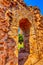 Qutb Minar tower seen through the ruined Quwwat ul-Islam Mosque at Qutub Minar complex - New Delhi, India