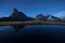 Ra Gusela reflects itself over a little alpine lake in Dolomites at night