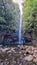 Rabacal - Father with baby carrier looking at majestic waterfall Cascata Risco along idyllic Levada walk 25 Fontes