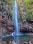 Rabacal - Hiker woman looking at majestic waterfall Cascata das 25 Fontes along idyllic Levada walk