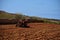 RABAT, MALTA - Oct 12, 2014: A tractor ploughing a field, of fertile terrarossa soil