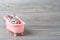 Rabbit in the bathtub placed on a wooden floor. Happy easter Fancy rabbit on a wooden background. Cute little rabbit on a pink