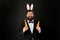 Rabbit bringing Easter carrots. Easter rabbit black background. Bearded man hold carrots. Happy businessman wear rabbit