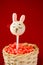 rabbit cake pops on red background.