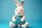 rabbit with lowered ears on blue background cute kids knitted toys
