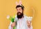 Rabbit man in bunny ears with flowers and basket eggs. Easter celebration concept. Bearded man in suit with Spring