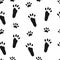 Rabbit paws. Seamless pattern with black footprints of hare on white background.