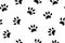 Rabbit paws. Seamless pattern with small black footprints of a hare on a white background.