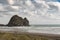 Rabbit rock at Piha Beach seen from along the beach.