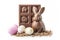 rabbit shaped chocolate with easter eggs isolated white