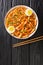 Rabokki is a type of tteokbokki with added ramyeon noodles it is a Korean street food closeup in the bowl. Vertical top view