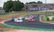 Race cars during formation lap on racetrack, prototype group of Le Mans series