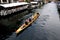 Race rowing boat sailing in christianshavn canal in Copenhagen