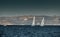 The race of sailboats, a regatta, reflection of sails on water, Intense competition, number of boat is on aft boats