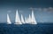 The race of sailboats, a sail regatta, reflection of sails on water, Intense competition, number of boat is on aft boats