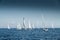 The race of sailboats, a sail regatta, reflection of sails on water, Intense competition, number of boat is on aft boats