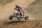 Racer is jumping a quad bike
