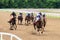 Racetrack horse racing jockey approaching the finish line, sports with horses