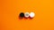 Racial equality concept. Black and white wood circles  on beautiful orange background. Copy space