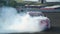 Racing car drift with smoking tyres