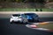 Racing car Renault Clio challenging at turn on racetrack motor sport action