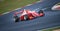 Racing car single seater modern formula in action at turn on wet asphalt track