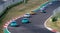 Racing cars Renault Clio battle for overtaking on asphalt circuit high angle view