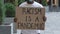 RACISM IS A PANDEMIC on cardboard poster in hands of African American male protester activist. Stop Racism concept, No