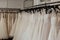 a rack of aline wedding dresses in a clean store setting