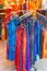 Rack of brightly colored summer dresses