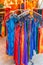 Rack of brightly colored summer dresses