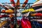 Rack of colorful kayaks and canoes.